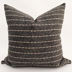 a black and white striped pillow sitting on top of a table