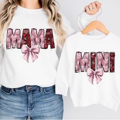 a woman wearing a white shirt with the word mama printed on it and a pink bow