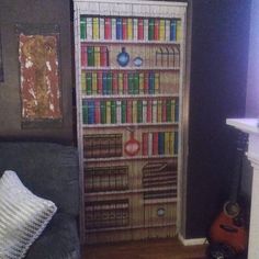 a living room with a book shelf and guitar