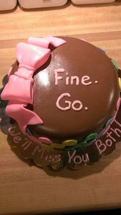 there is a chocolate cake with pink bows on it that says fine go between you both