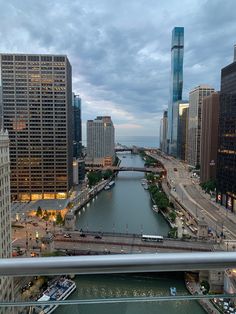 a river running through a large city next to tall buildings on either side of it