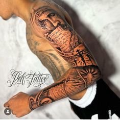 a man's arm with tattoos on it and an image of a cross in the background