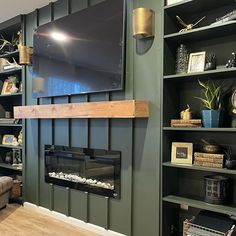 a living room filled with furniture and a flat screen tv mounted on the wall above a fire place