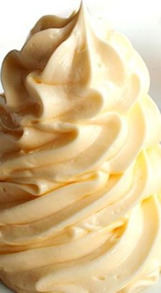 a close up of a cupcake on a plate with frosting and icing