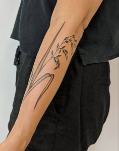 a woman with a tattoo on her arm holding a knife in one hand and flowers in the other