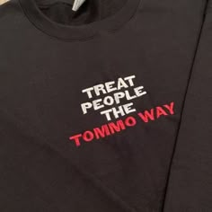 a black t - shirt that says treat people the tommo way on it's chest