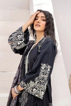 Stitched Embroidered Lawn Shirt with Silk Dupatta Color: Black This gorgeous 2 pc stitched Embroidered Lawn Shirt & Silk Dupatta is sure to make a statement. The perfect blend of sophistication and style, this 2pc stitched ladies suit is perfect for any special occasion. Crafted from the finest fabrics, it is sure to make a lasting impression. Long Sleeve Blouse With Dabka Work For Eid, Unstitched Floral Embroidered Blouse For Eid, Long Sleeve Blouse With Floral Embroidery For Eid, Floral Embroidery Long Sleeve Blouse For Eid, Long Sleeve Cambric Kurta With Multicolor Embroidery, Eid Long Sleeve Blouse With Embroidered Sleeves, Long Sleeve Cotton Blouse For Eid, Traditional Long Sleeve Embroidered Top For Eid, Multicolor Embroidered Tops For Eid