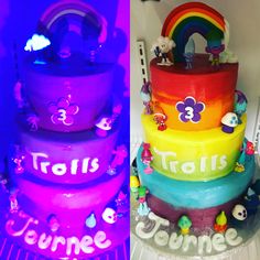 there is a three tiered cake decorated with rainbows