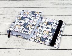 a small notebook with cats on it