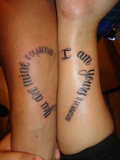 two people with matching tattoos on their arms that read i am and e are both holding each other's hands