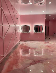 a room with pink walls and mirrors on the wall, lights in the ceiling and floor