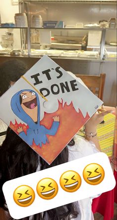 a woman holding up a sign that says it's donee with smiley faces