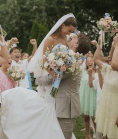 the bride and groom are surrounded by their wedding party