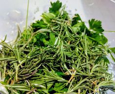 fresh herbs are mixed together in a bowl