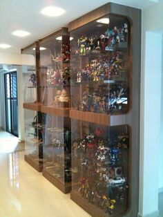 a display case filled with lots of toy figurines on shelves in a building