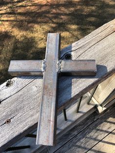 a wooden cross sitting on top of a wooden bench