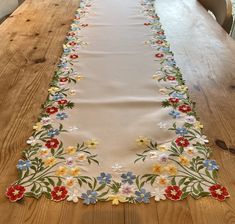 a table runner with flowers and leaves on it