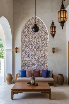 a living room filled with lots of furniture next to a wall covered in hanging lights