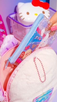 a hello kitty purse is shown with other items