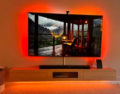 a flat screen tv sitting on top of a wooden stand