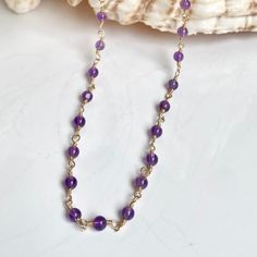 This eye-catching amethyst necklace features an intricate rosary style design. The premium craftsmanship and classic design make this necklace a timeless addition to any jewelry collection. Length 16" Amethyst is a highly mystical stone that heightens our sense of justice and encourages us to act from a place of deep integrity. Amethyst makes an extremely good meditation stone and can help to quiet the mind from distractions. Crown chakra. -This information is intended for spiritual support only Elegant Amethyst Wire Wrapped Necklaces, Elegant Wire Wrapped Amethyst Necklace, Elegant Amethyst Wire Wrapped Necklace, Spiritual Amethyst Jewelry With Lobster Clasp, Wire Wrapped Amethyst Necklaces With Round Beads, Purple Wire Wrapped Necklaces With Round Beads, Purple Wire-wrapped Necklaces With Round Beads, Quiet The Mind, Best Meditation