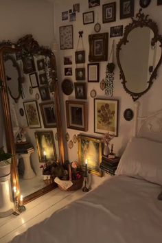 a bedroom with pictures and candles on the wall