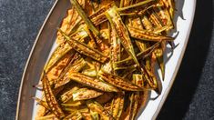 grilled green beans on a white plate