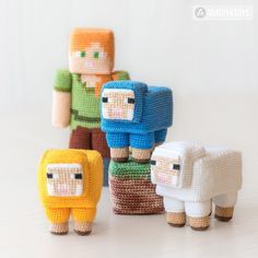 four small knitted sheep standing next to each other