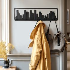 a coat rack and purse hanging on a wall