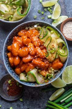 two bowls filled with chicken and vegetables on top of a table