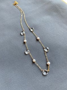 🌟🌟🌟A perfect balance in harmony - pearls and clear quartz.  This necklace lies delicately at the base of the throat.  Makes a great gift for your bridesmaids or yourself.+ Picture #2 was a collection made for a bridal party.+ Quartz. Freshwater Pearls. Gold Fill Chain & Lobster Clasp.+ Necklace measures 17 inches (43.18 cm) in length.+ Necklace takes 1 business day to ship.+ Your jewelry will come in a jewelry box, tied with our a ribbon.+ Listing is for one (1) necklace.+ Bridal discount Elegant Crystal Necklace With Delicate Chain, Elegant White Crystal Necklace With Pearl Chain, Elegant White Faceted Necklaces, Elegant Faceted Pearl Necklace, Pearl Necklaces With Faceted Detail As Gift, Elegant Crystal Necklaces With Pearl Drop, Elegant Clear Single Strand Crystal Necklace, Elegant Single Strand Clear Crystal Necklace, Elegant Single Strand Crystal Necklace