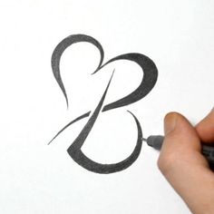 someone is drawing the letter b on paper