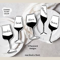 three wine glasses with names on them sitting on a plate next to another set of plates