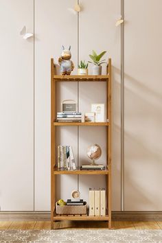 a wooden shelf with books and plants on it