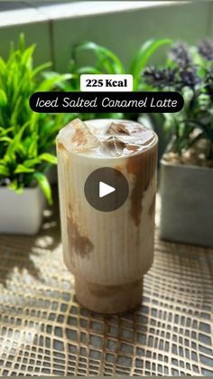 iced salted caramel latte on a table in front of potted plants