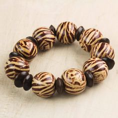 a close up of a bracelet with zebra print beads on it's end and one bead in the middle