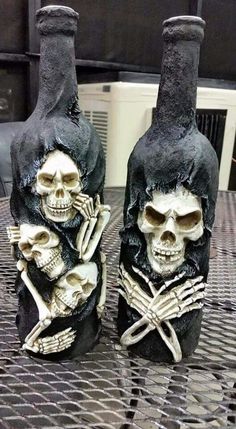 two skeleton wine bottles sitting on top of a table