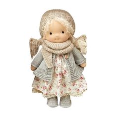 an angel doll wearing a knitted hat and scarf