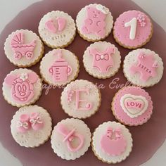 pink and white decorated cookies on a plate