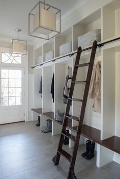 a ladder is in the middle of a walk - in closet