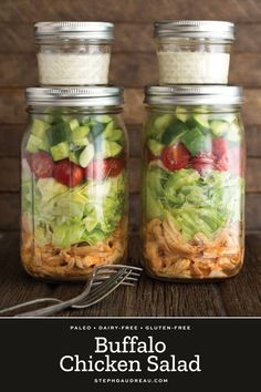 two mason jars filled with salad ingredients and the words buffalo chicken salad in front of them