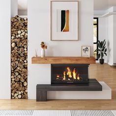 a fire place in the middle of a living room with wood stacked on it's sides