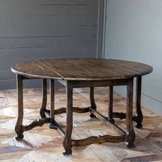 a wooden table sitting on top of a tiled floor