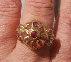 This true antique ring is luscious on all sides. The top of the ring is early 18th century and it is dotted with genuine rubies with a central floral pattern and tri shaped sides. This particular style of ring is typical of the 18th century Iberian area, most likely Portugal. The top was affixed on to a 14k gold ring  (marked 14k),shank that is elaborately hand chased and custom made by a very competent gold smith to mirror the side profiles of the ring head. The shank is marked 14k and is presently a size 6 1/2. The shank is substantial in its weight and thickness. The style of the ring suggests this work was done in 1920's. The central ruby has been replaced as well as one of the petal rubies, but this is nicely done.  A very nice ring that is very comfortable to wear. Follow me on insta Side Profiles, Rubin Ring, Crystal Heart Pendant, Victorian Gold, Antique Ring, Beautiful Rocks, Puffy Heart, Tahitian Pearls, 14k Gold Ring