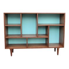 a wooden shelf with blue glass shelves on it