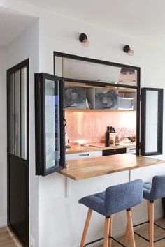 two stools sit at the bar in this modern kitchen