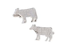 two silver cows are shown on a white background