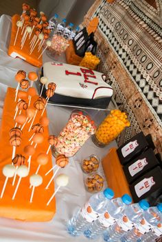 a table topped with lots of cakes and candy