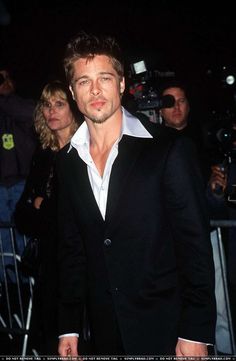 a man wearing a black suit and white shirt