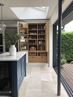 a kitchen with blue cabinets and white counter tops